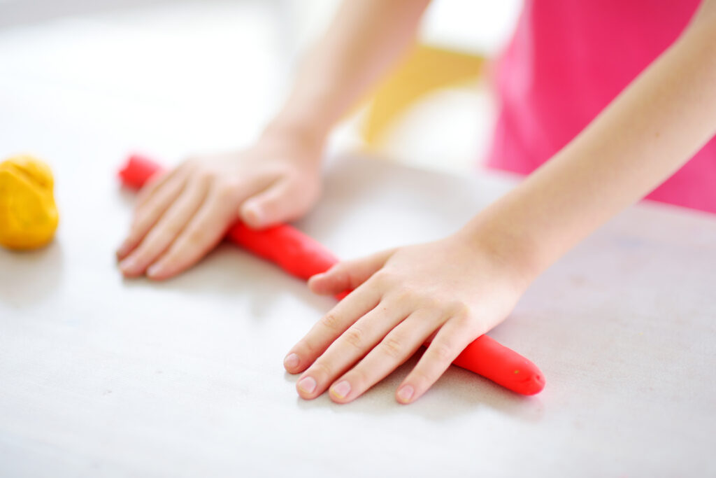 Clay Art Making Relieves Stress, child rolling clay out