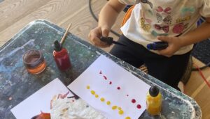 child using droppers, for mixing colors